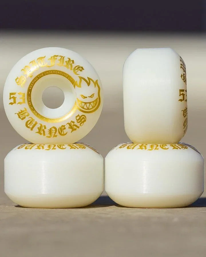 Four off-white skateboard wheels stacked in a 2x2 arrangement, featuring gold foil graphics and the text 'SMOKER FURY' and '50MM'.