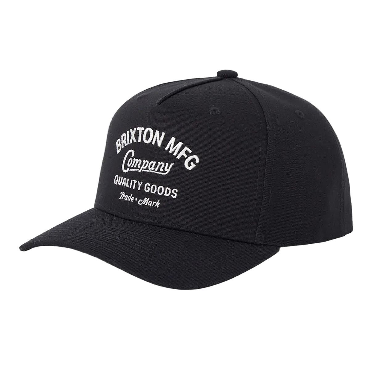 A black baseball cap with white embroidered text reading 'Brixton MFG Company Quality Goods' on the front, shown against a light gray background.