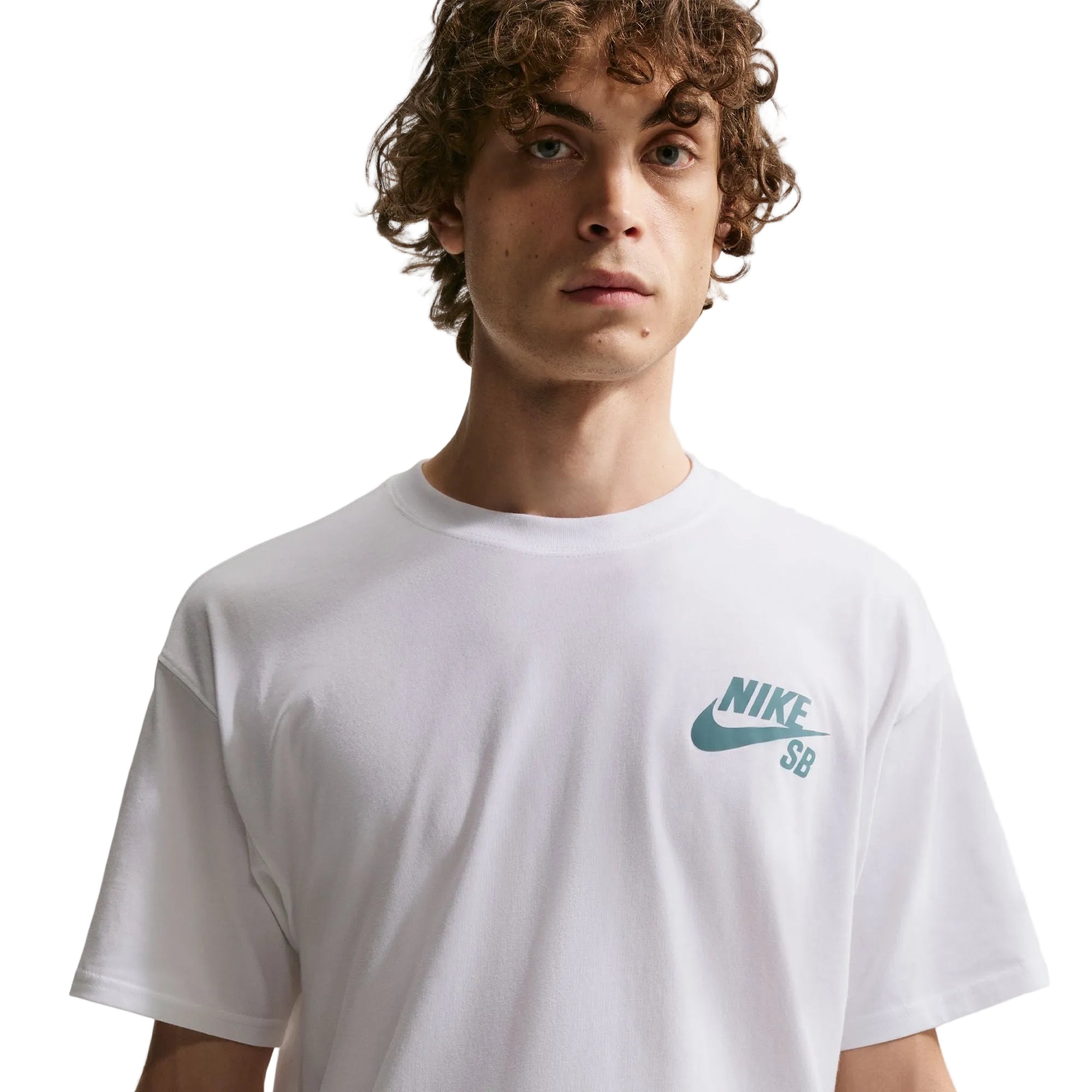 Person wearing a white Nike SB t-shirt with a blue logo on a light gray background