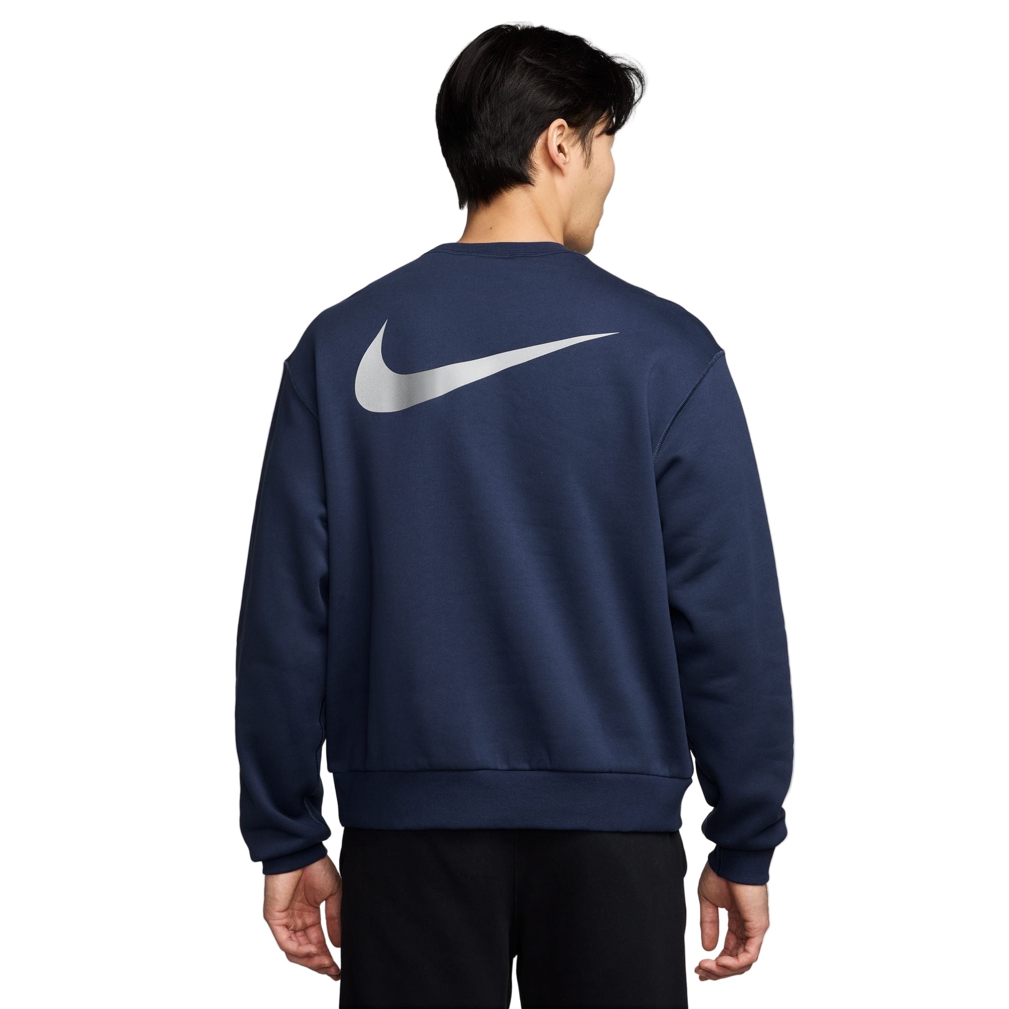 Person wearing a navy blue sweatshirt with a large white logo on the back, on a white background
