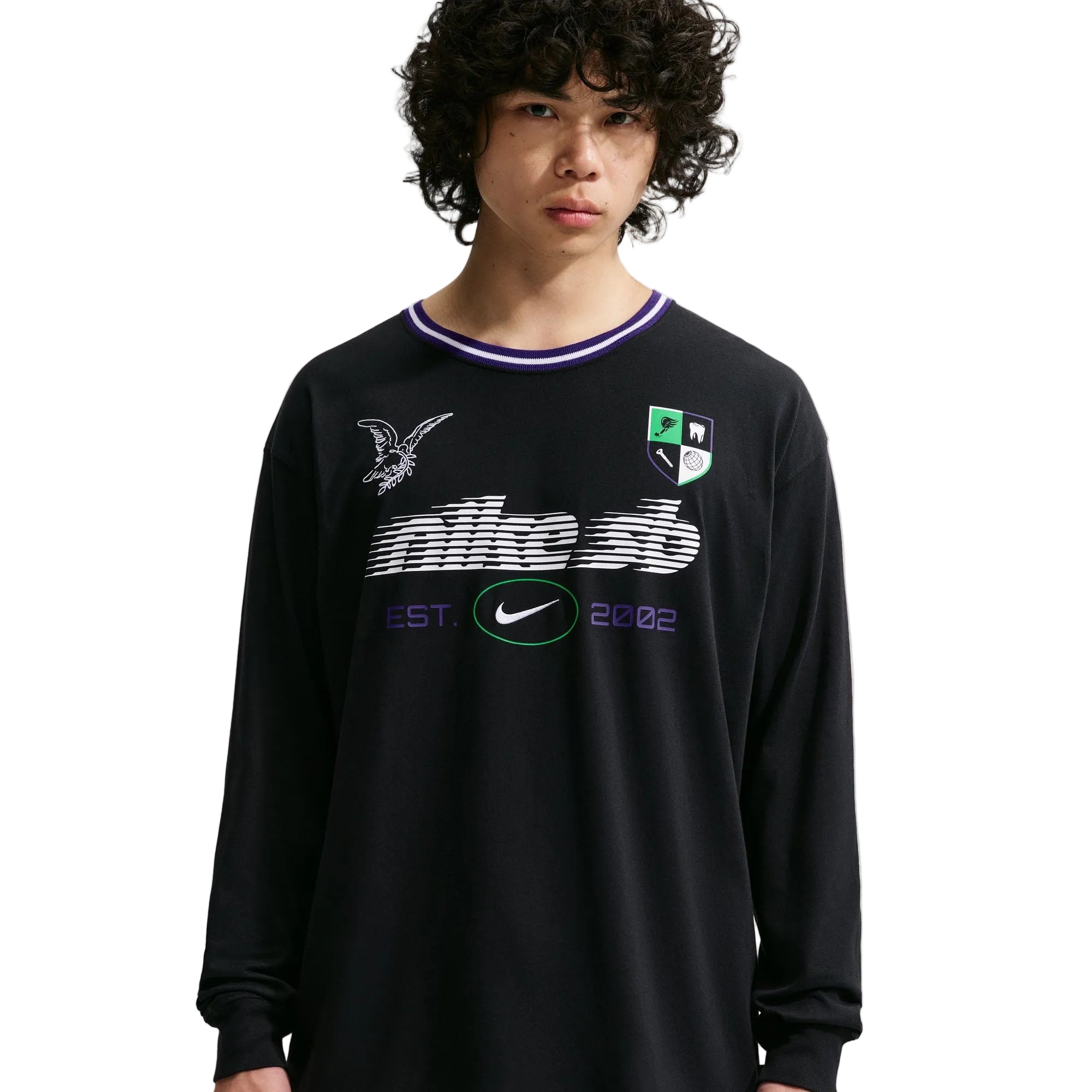 Person wearing a black long-sleeve shirt with logos on a white background