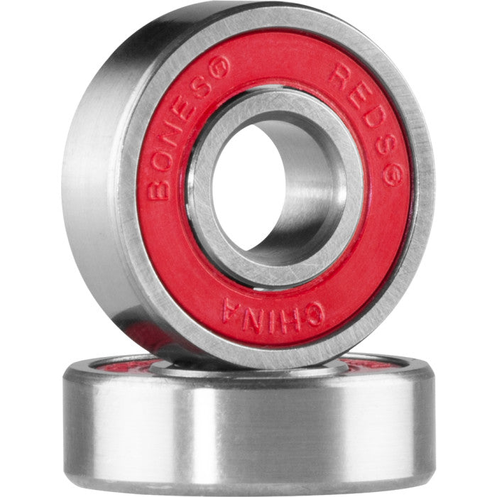 Two skateboard bearings with red inner races on a white background
