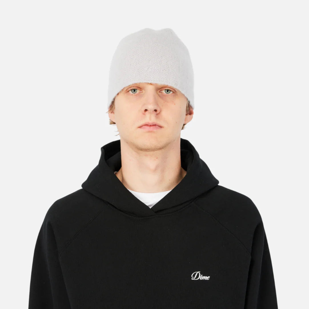 Person wearing a black hoodie with a logo on a white background