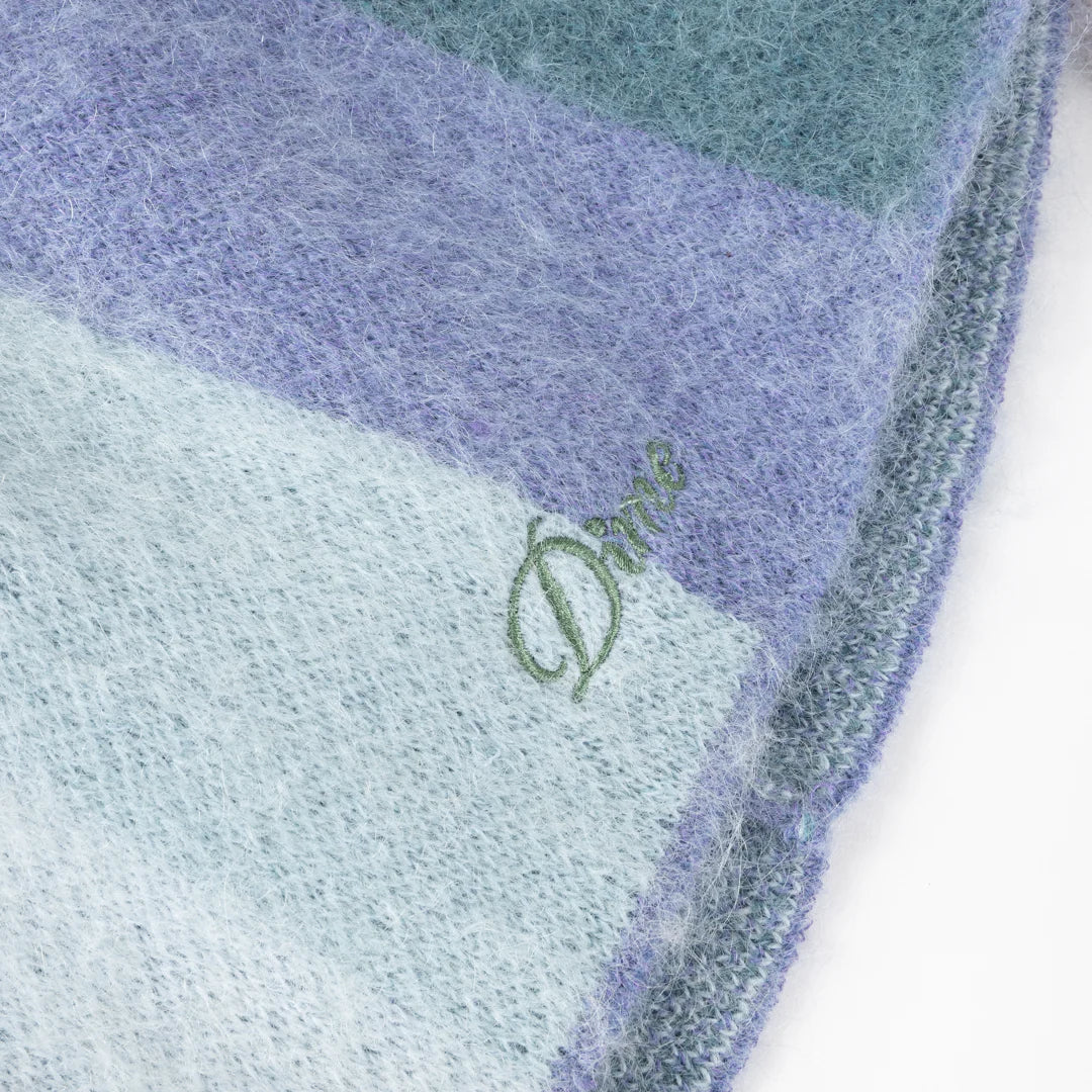 Multicolored fabric with a green logo on a white background