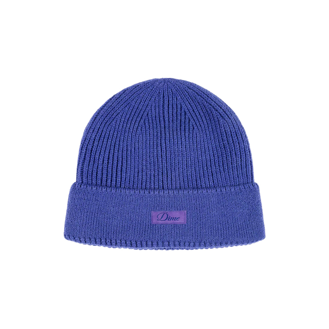 Blue beanie with a small logo on a light gray background