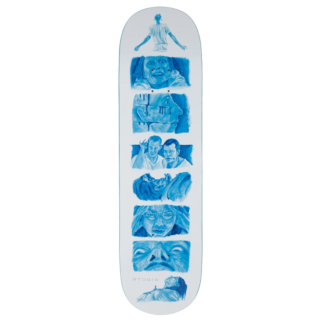 A skateboard deck with a white background and a vertical blue graphic collage of illustrated faces and figures, with the brand name STUDIO printed near the bottom.