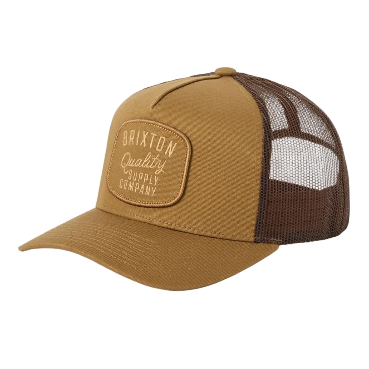 A trucker-style baseball cap in tan and dark brown, featuring a curved brim, tan mesh back panels, and a tan patch on the front with the text 'Brixton Quality Supply Company'.