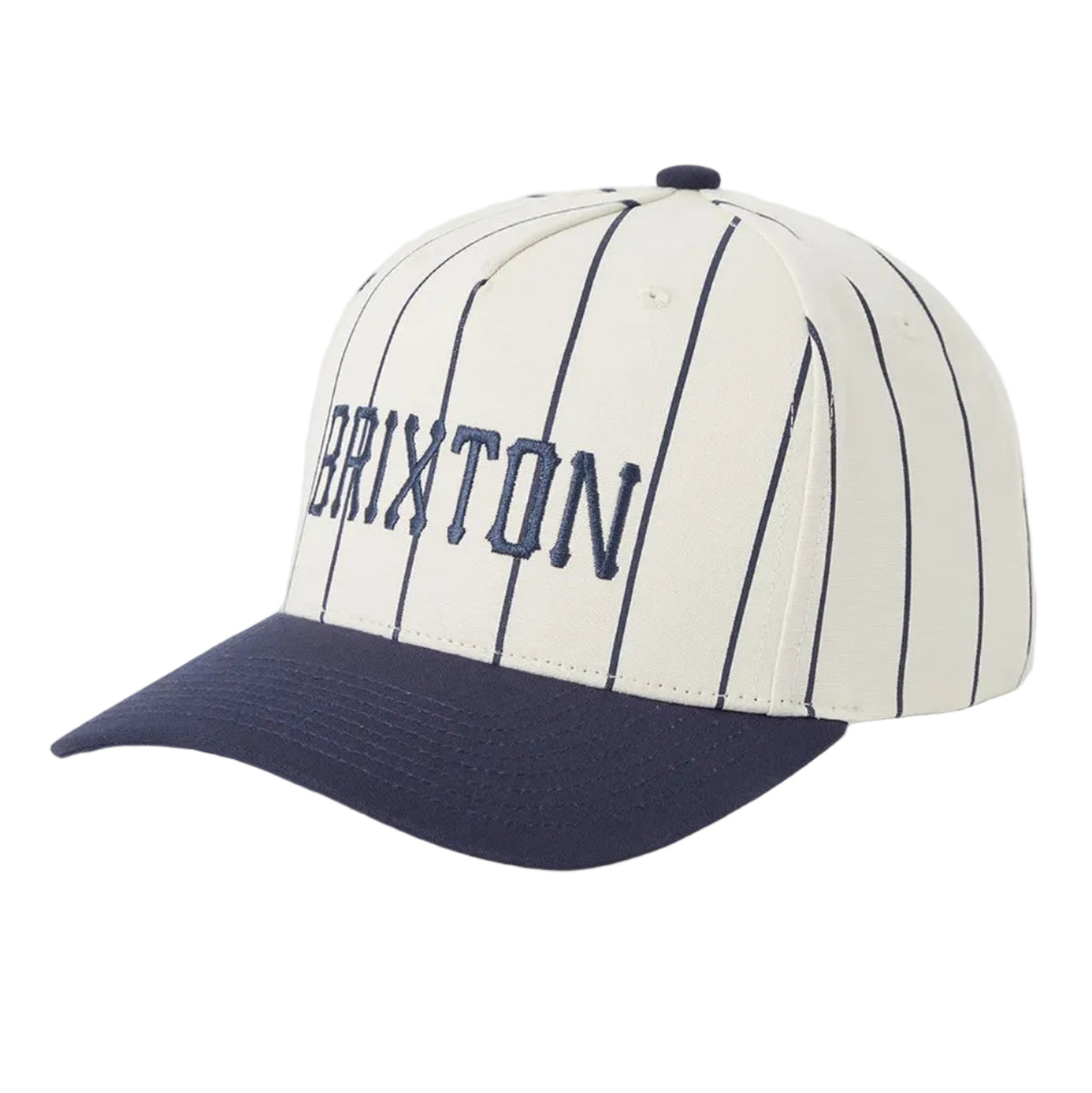 A baseball cap with an off-white crown featuring navy blue pinstripes and 'BRIXTON' embroidered in navy on the front, with a solid navy blue curved brim.