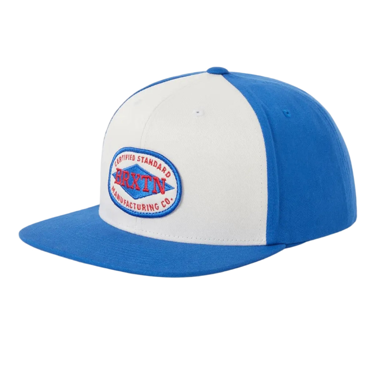A two-tone blue and white snapback cap featuring a circular embroidered patch on the front panel with the text 'Certified Standard BRXTN Manufacturing CO.' patch