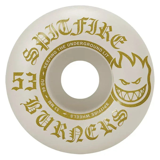 An off-white skateboard wheel featuring gold foil graphics, including the 'Spitfire' brand name, 'Burners' text, and the signature flame head logo.