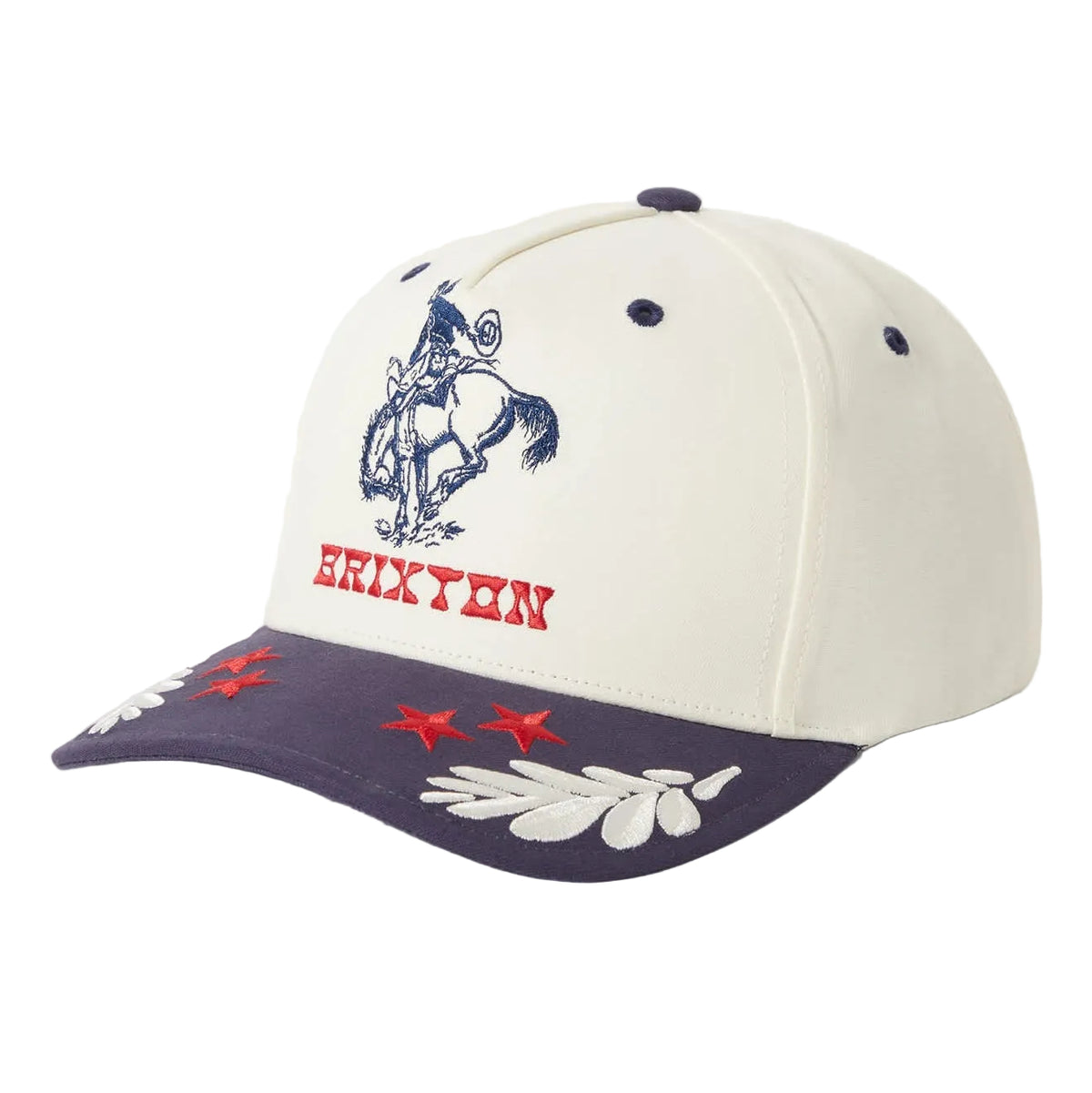 A structured baseball cap with an off-white crown, a dark navy blue visor, and embroidered details. The front crown features a navy blue cowboy on a horse with the word 'BRIXTON' embroidered in red below it.