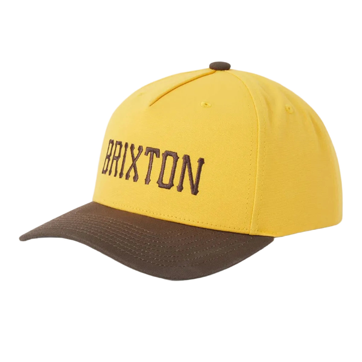 A yellow and brown baseball cap with 'BRIXTON' embroidered in brown on the front, shown on a light gray background.