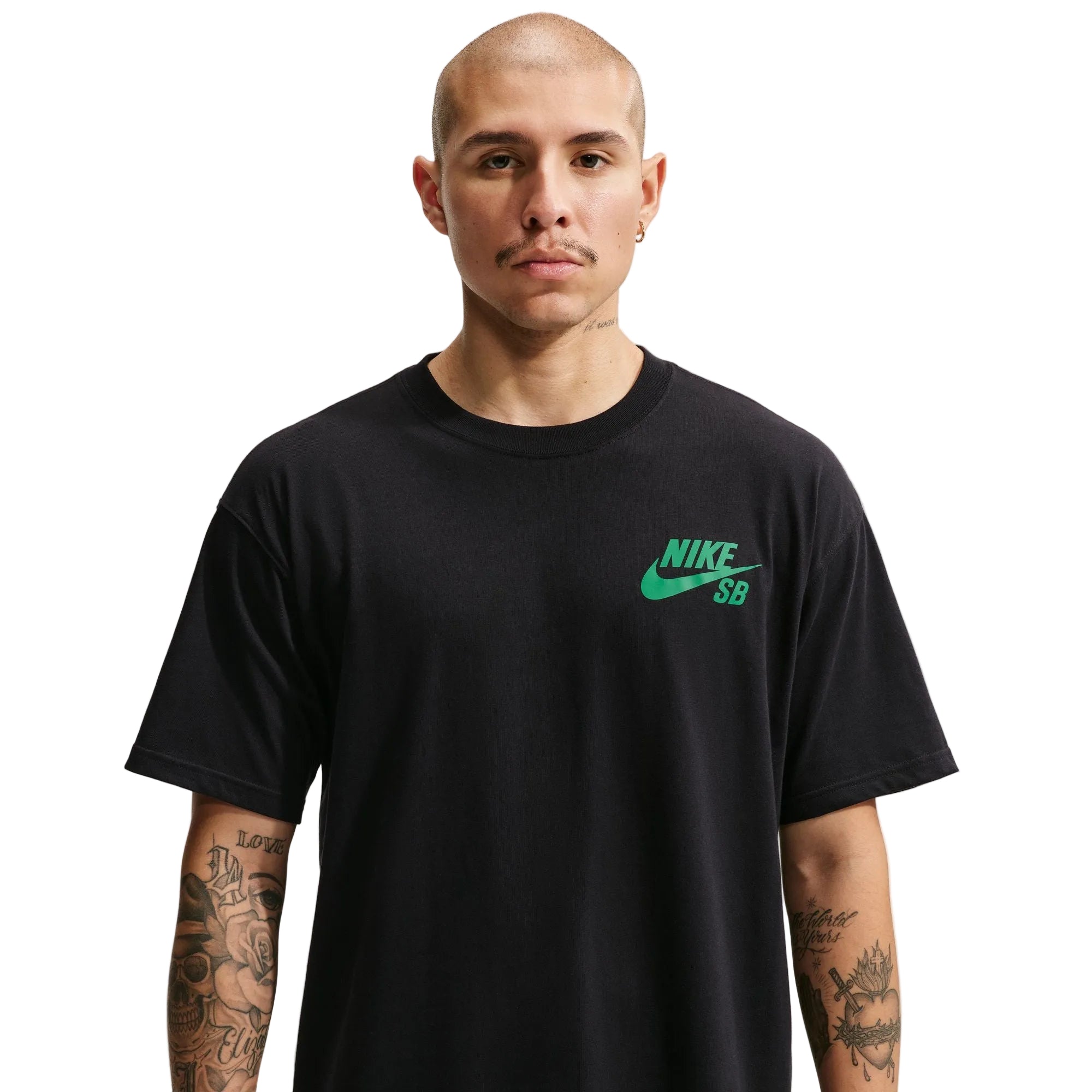 A man wearing a black short-sleeve crewneck t-shirt with a green Nike SB logo on the left chest, set against a plain light gray background.