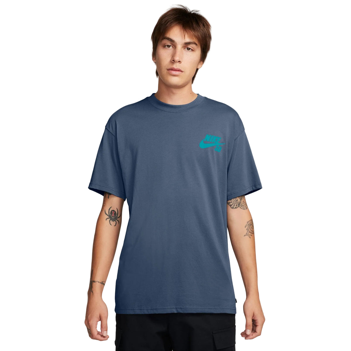 A man wearing a slate blue crewneck t-shirt with a small turquoise Nike logo on the left chest, photographed against a clean white background.