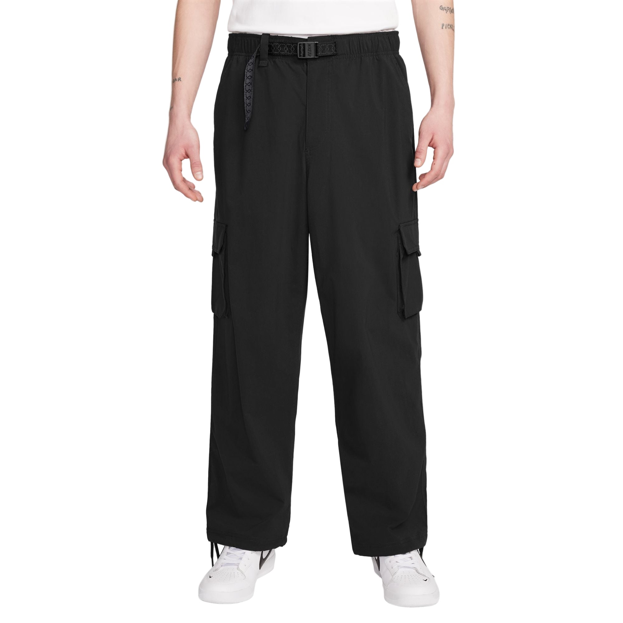Person wearing black cargo pants on a white background