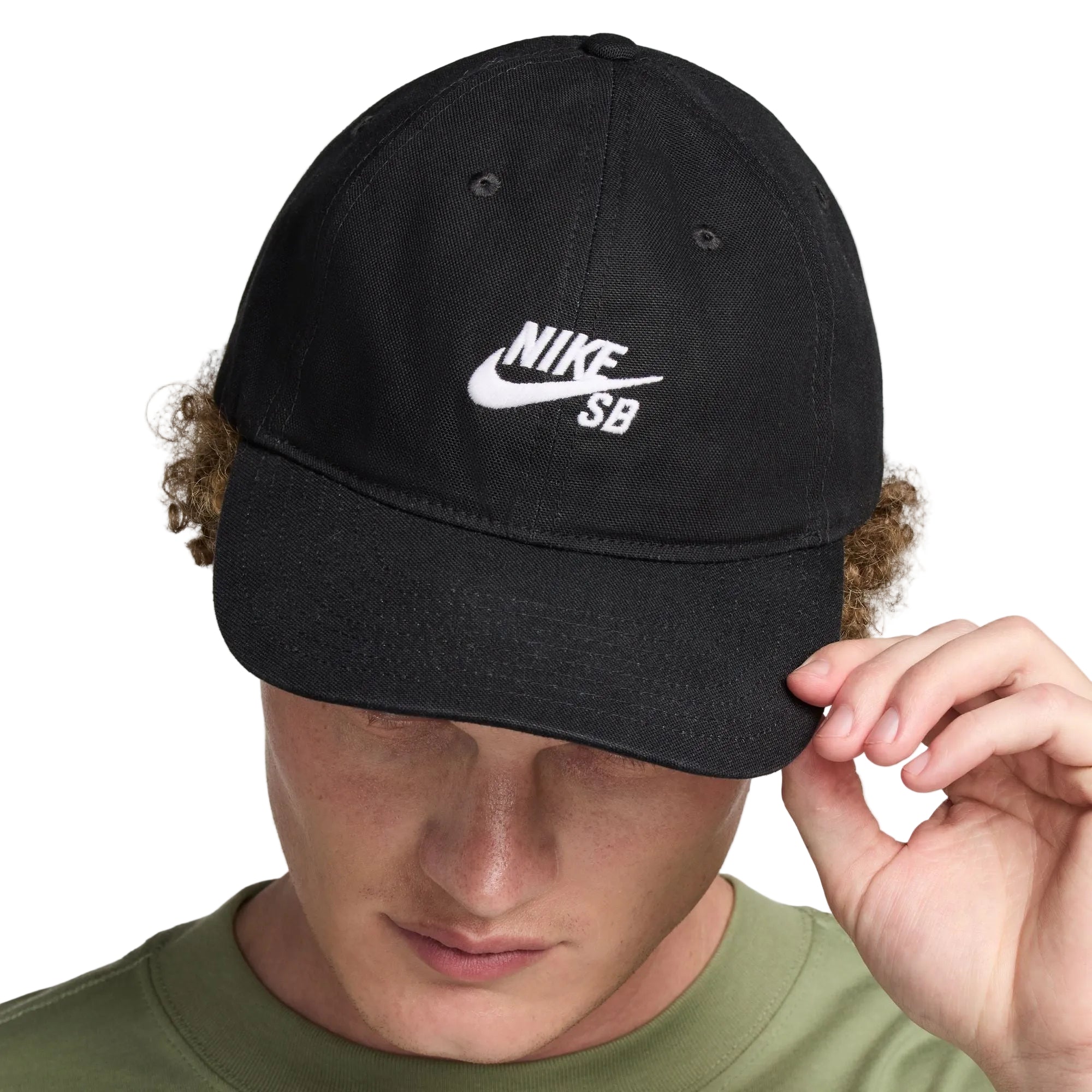 Person wearing a black Nike SB cap against a plain background