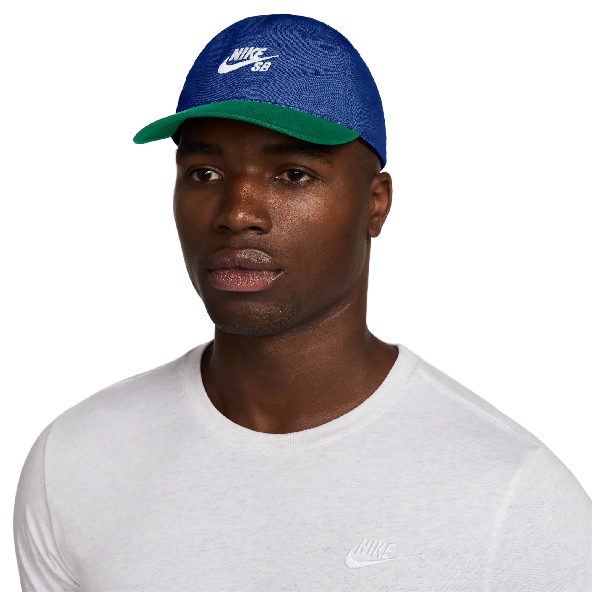Man wearing a blue Nike cap with a white background