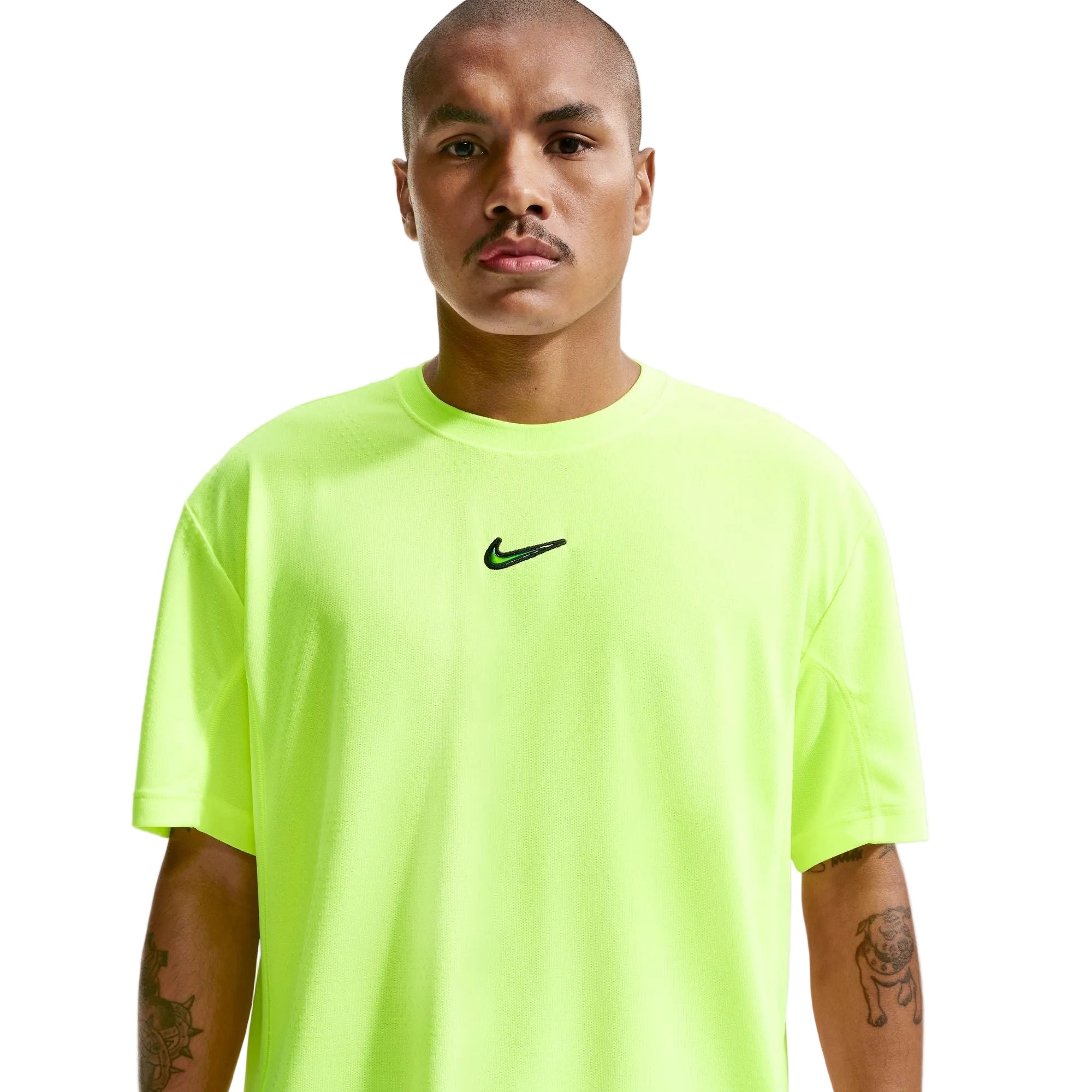 Person wearing a bright green Nike t-shirt with a black logo on a light gray background