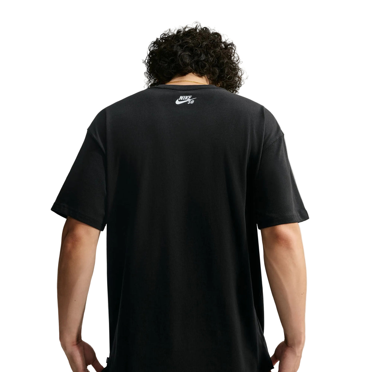A man viewed from behind wearing a black Nike t-shirt with a small white Nike logo on the upper back, set against a light gray studio background.