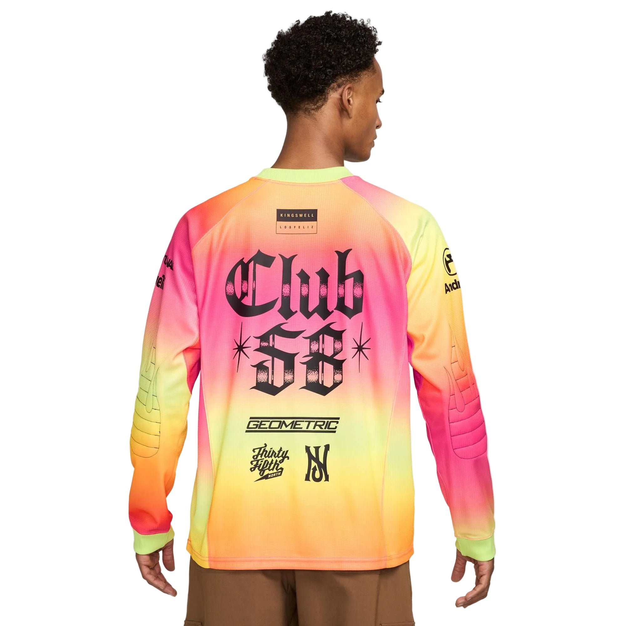 Person wearing a colorful long-sleeve shirt with branding on a white background