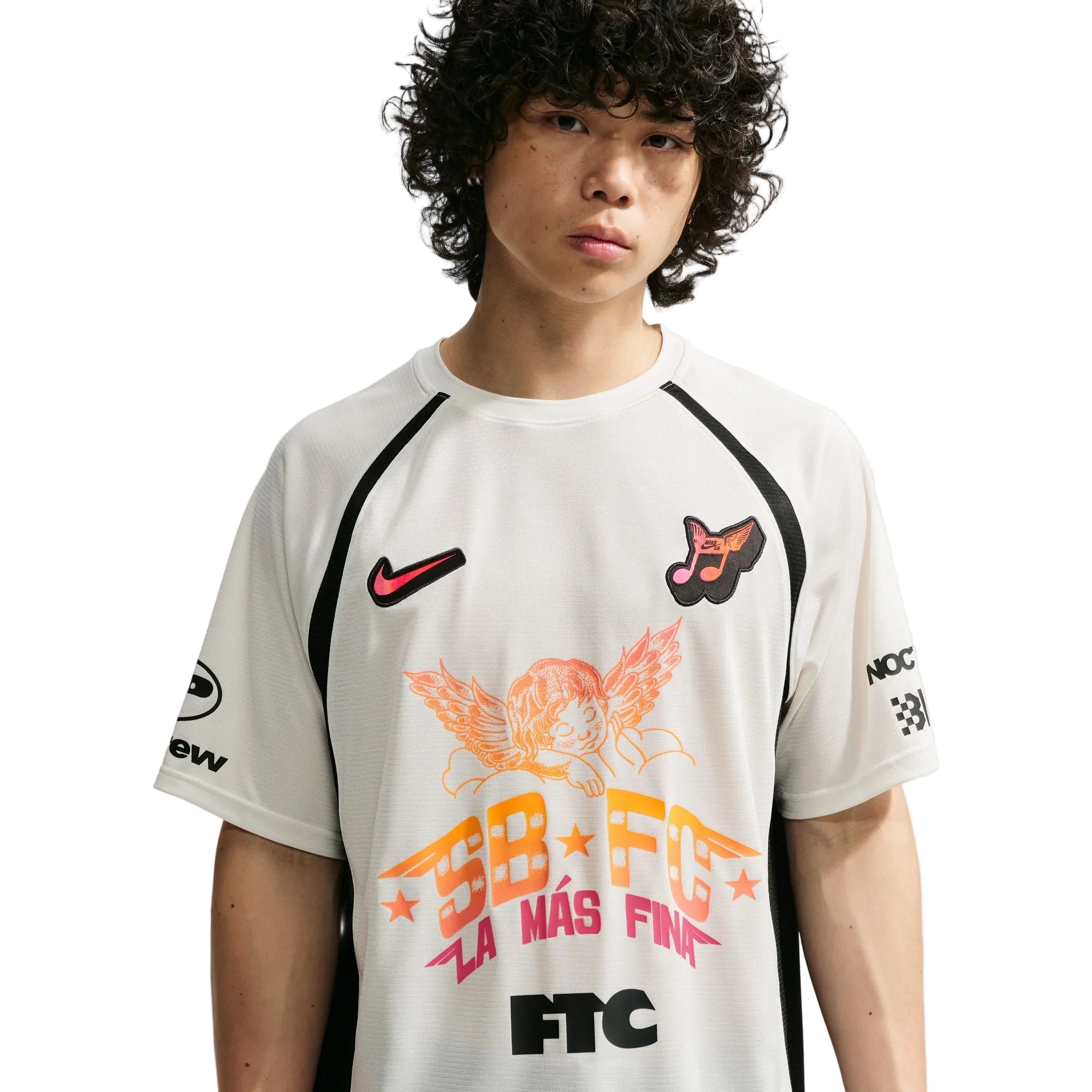 Person wearing a white sports jersey with various logos and text on a light gray background