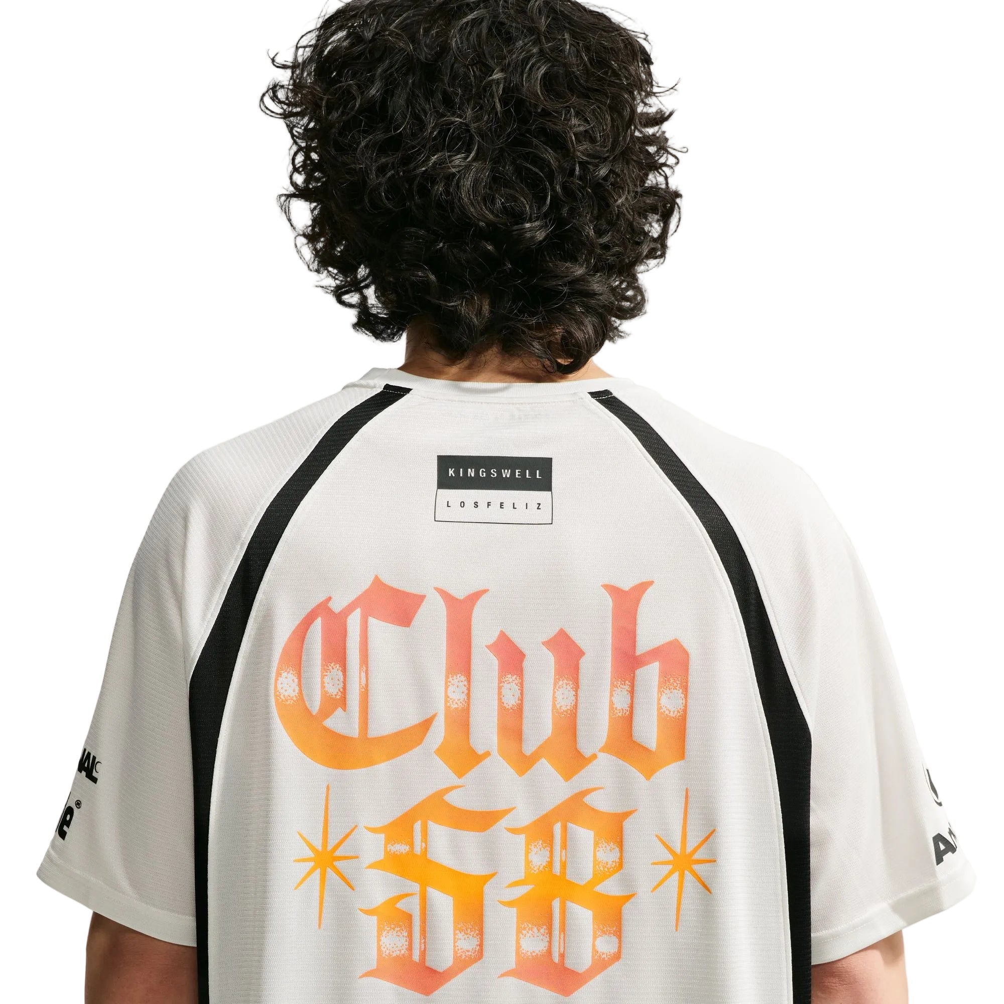 Person wearing a white t-shirt with 'Club SB' text on the back, brand logo visible.