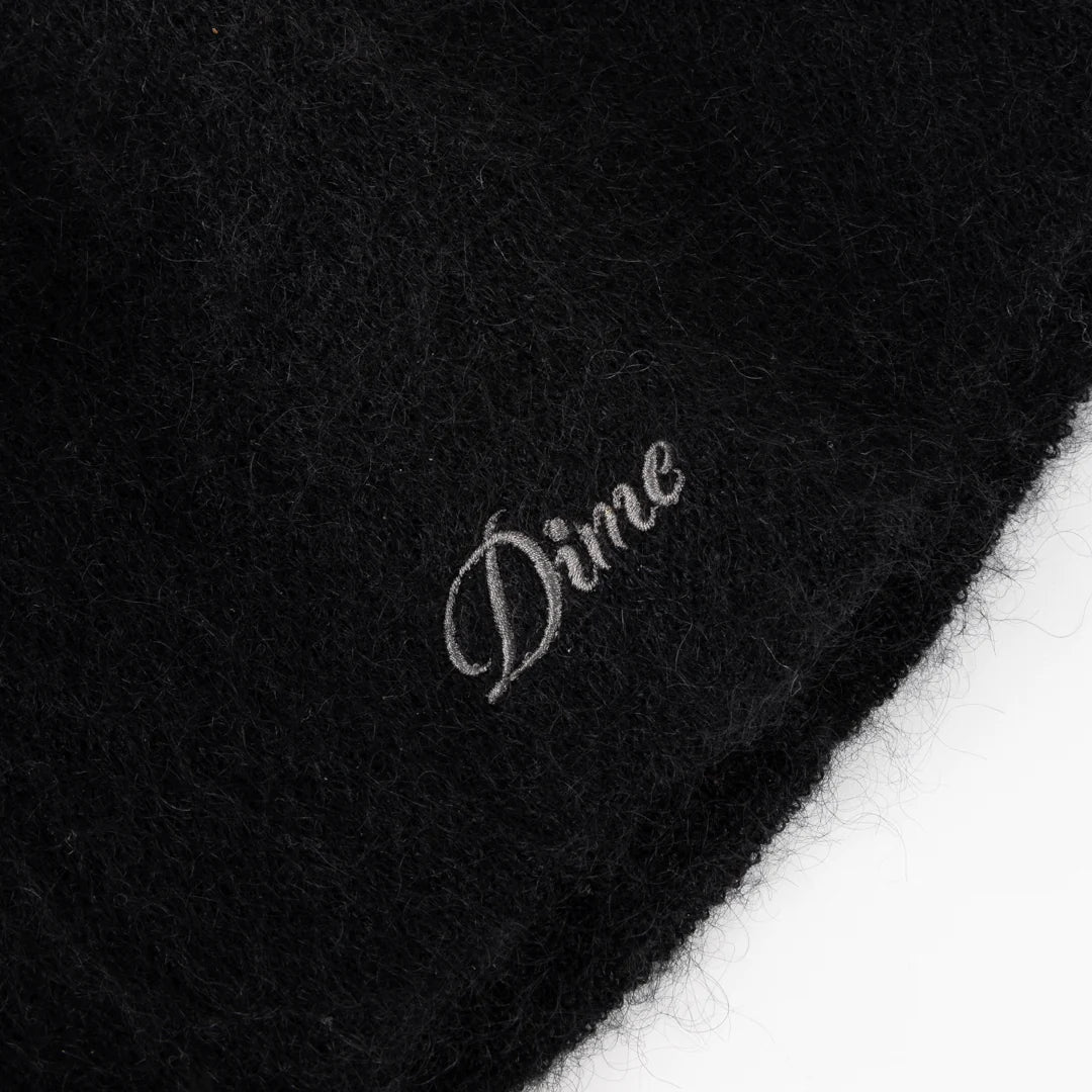 Black fabric with 'Dime' logo embroidered on it