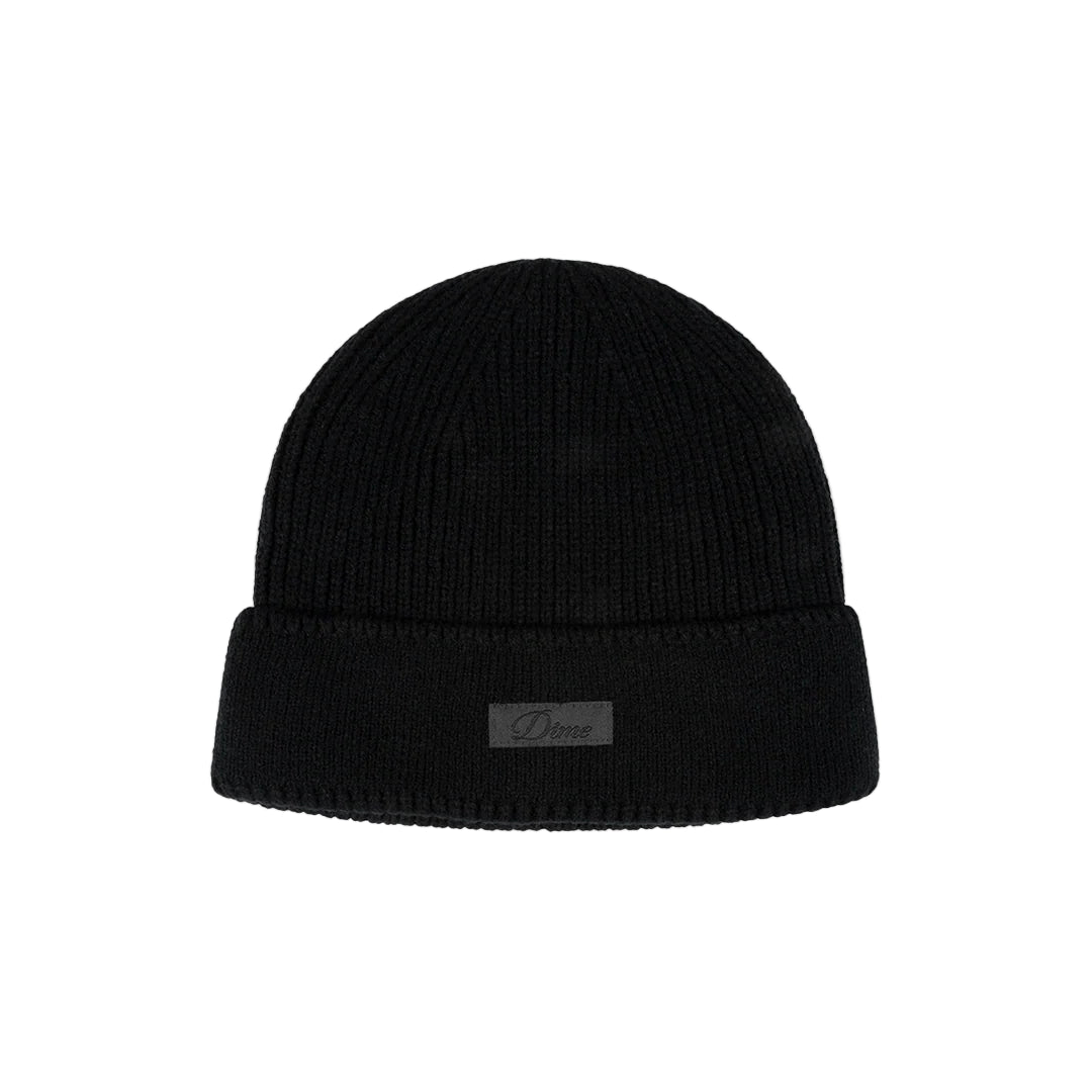 Black beanie with a small label on a light gray background