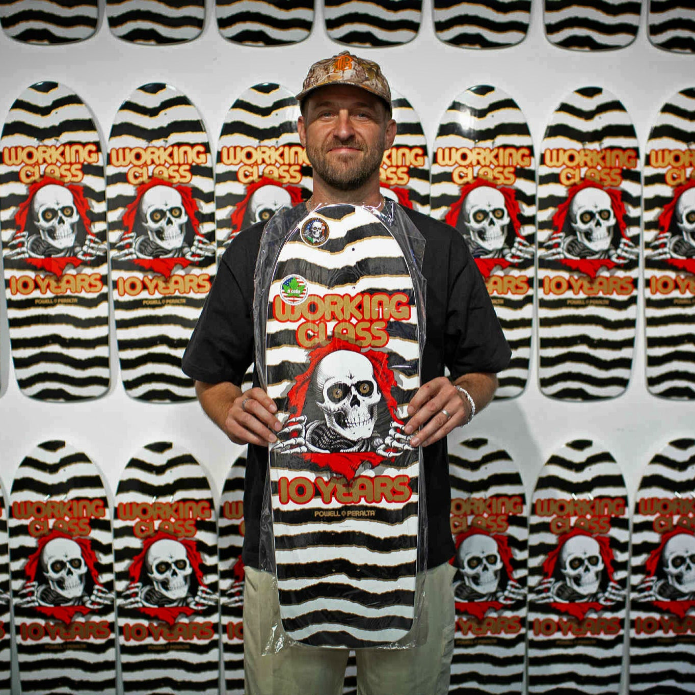 Justin Allain (Working Class Owner) stands proudly holding the limited edition Working Class x Powell Peralta Ripper deck.