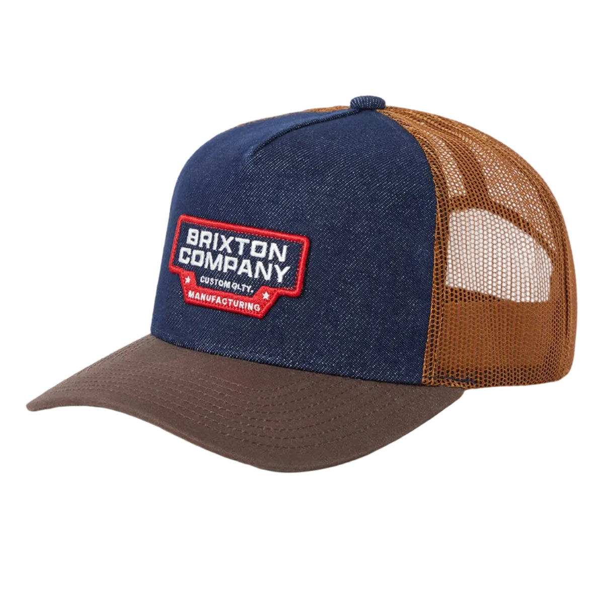 A Brixton Company trucker cap featuring a blue denim front panel and brim, brown mesh back panels, and a red and white embroidered logo patch on the front.